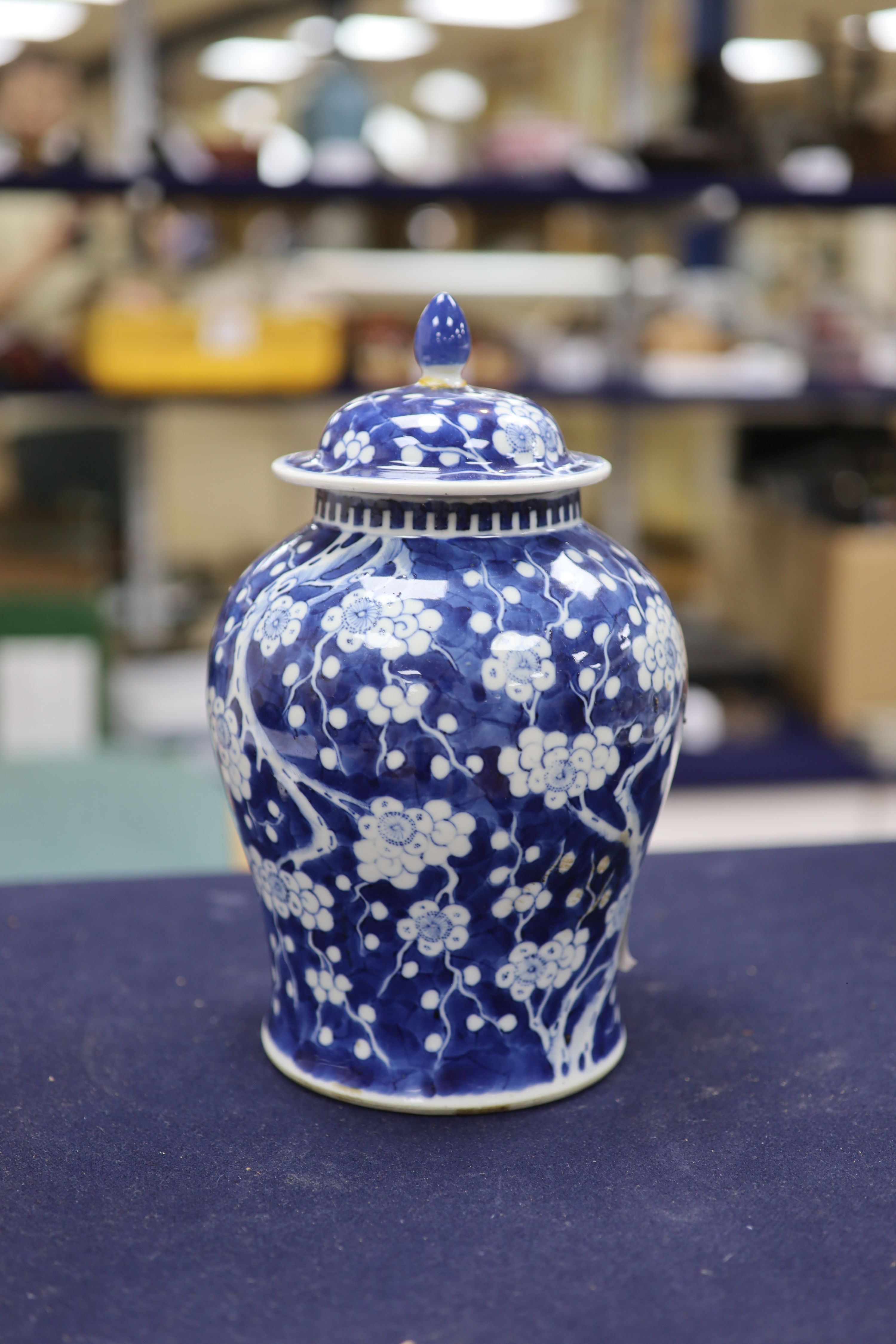 A 20th century Chinese blue and white jar and cover with prunus decoration, height 25cm